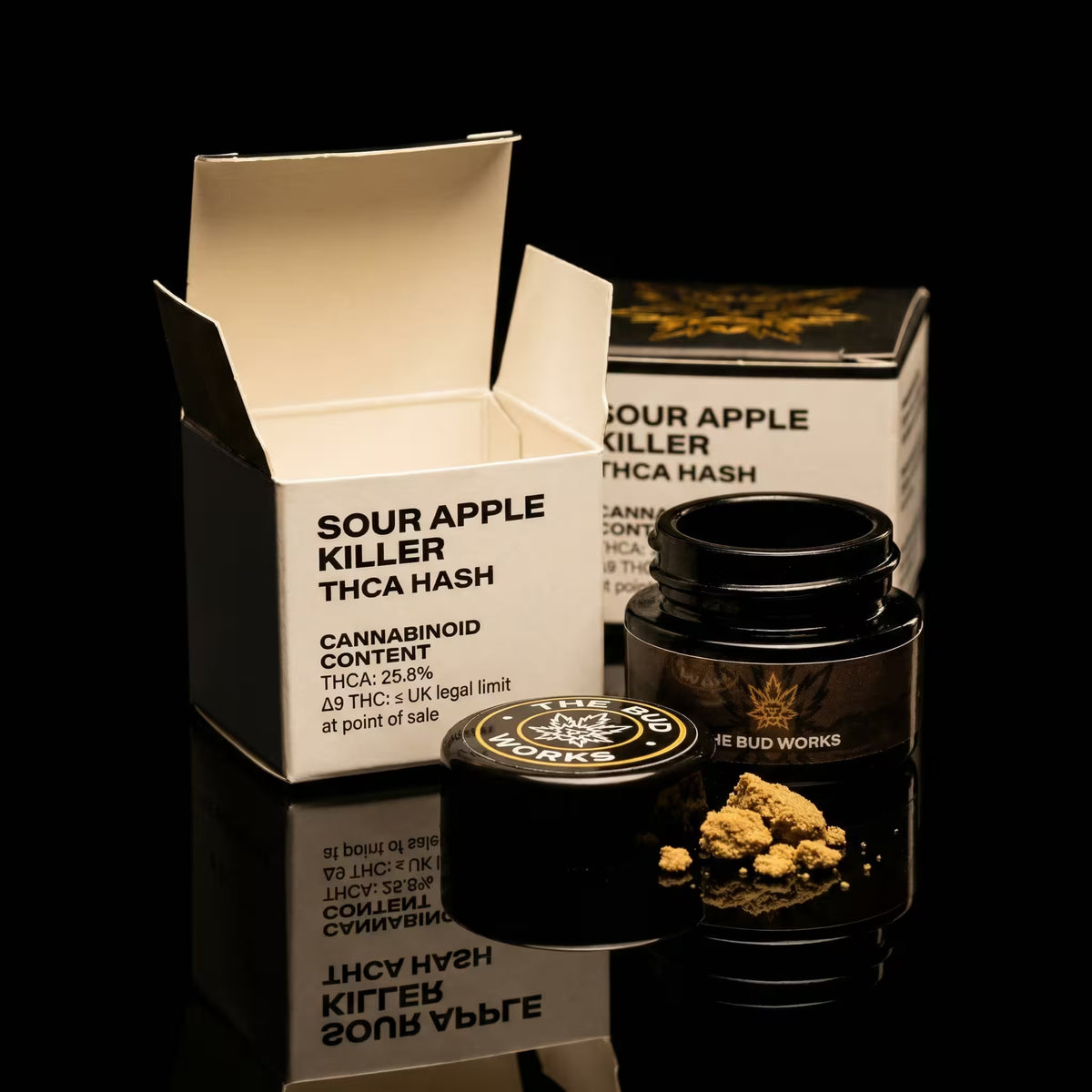Sour Apple Killer THCA Hash product with packaging on a black background