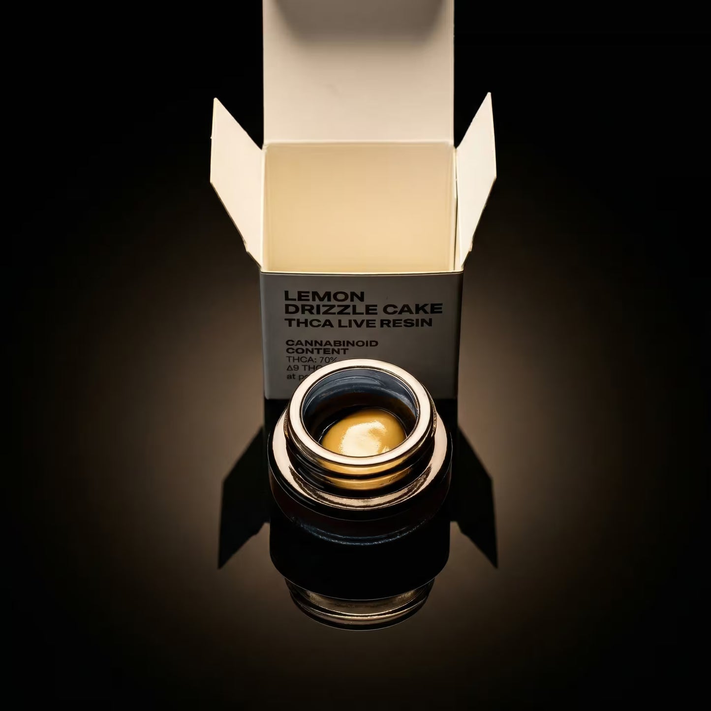 thca concentrate container with 'Lemon Drizzle Cake' label on a reflective surface.