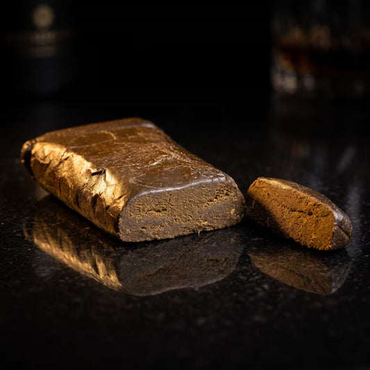Hash bar on a reflective black surface with a dark background.