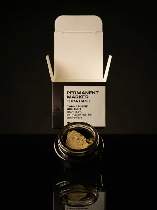 Permanent Marker Hash in a black jar with a branded box behind on a black background.