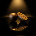 LCG Temple Ball THCA hash close-up — textured surface detail, dark moody lighting.