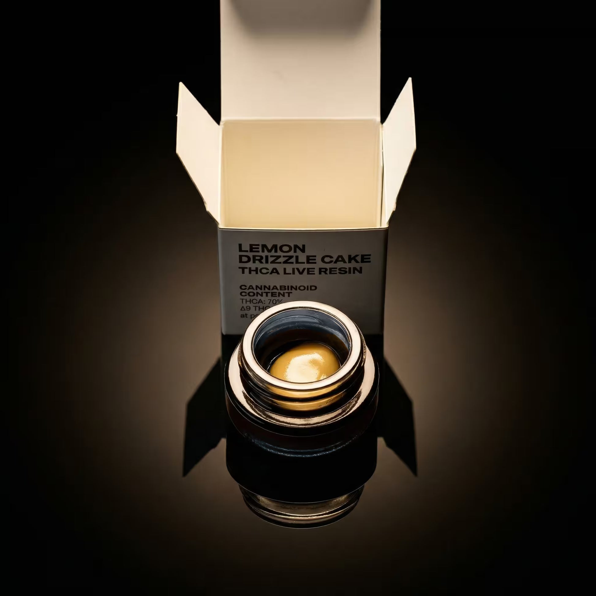 thca concentrate container with 'Lemon Drizzle Cake' label on a reflective surface.
